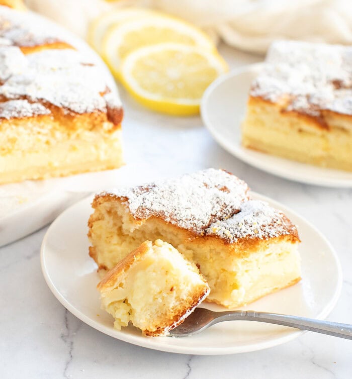 A bite of lemon magic cake on a fork