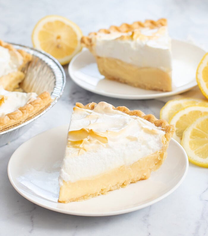 A slice of lemon pie on a white plate