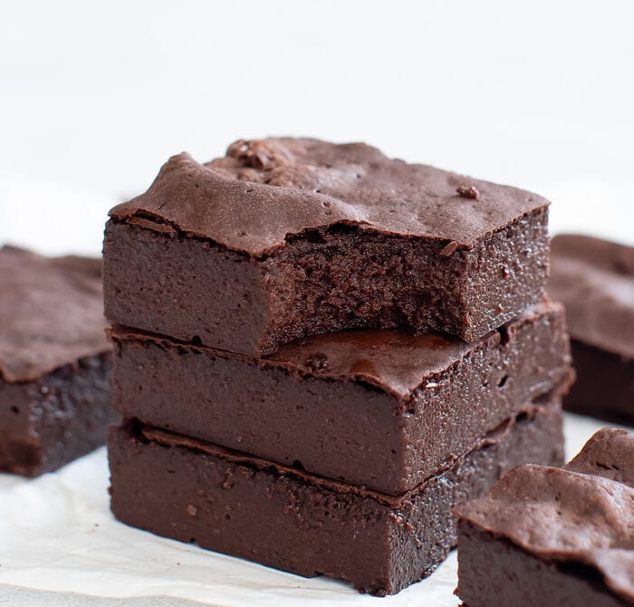 stack of brownies with one on top with a bite taken out of it