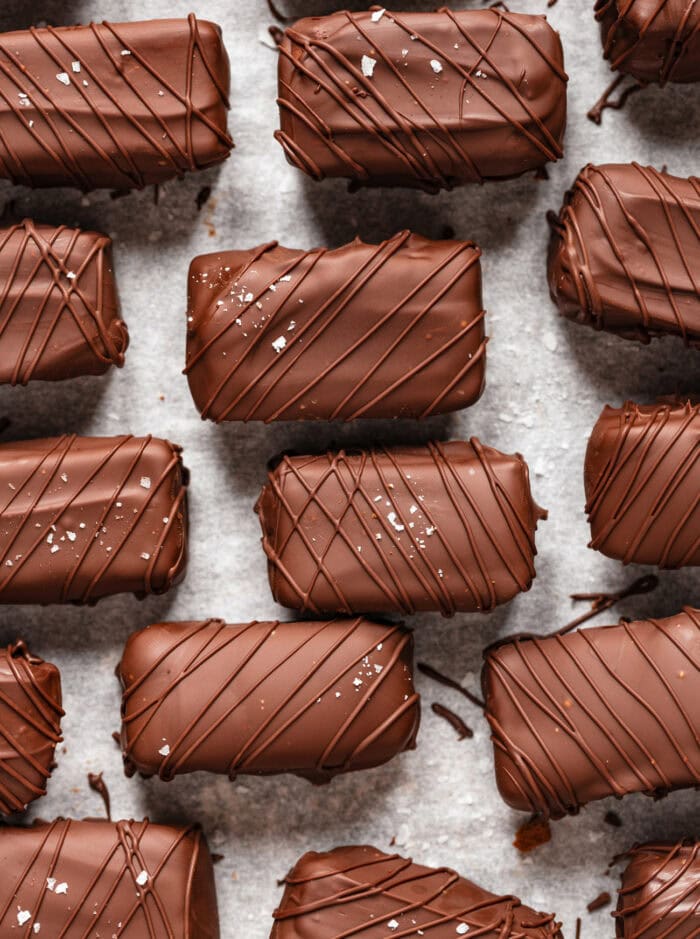 Chocolate candy bars decorated with a chocolate drizzle and sea salt 