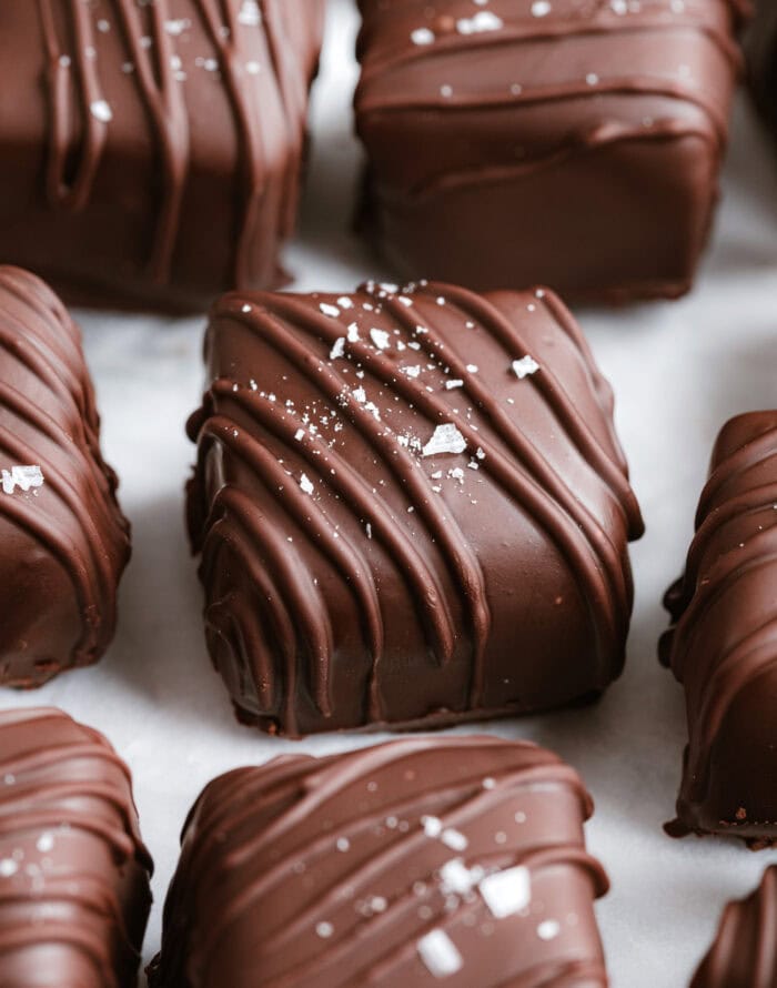 Chocolate candy bars drizzled with chocolate and topped with coarse salt