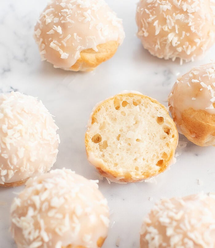 A coconut donut cut in half