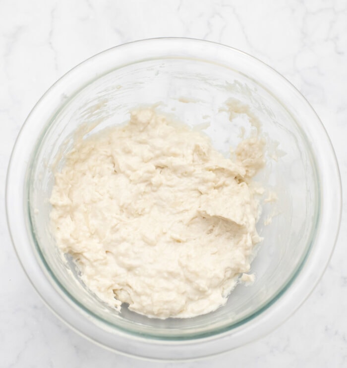 Batter for coconut donuts in a glass bowl
