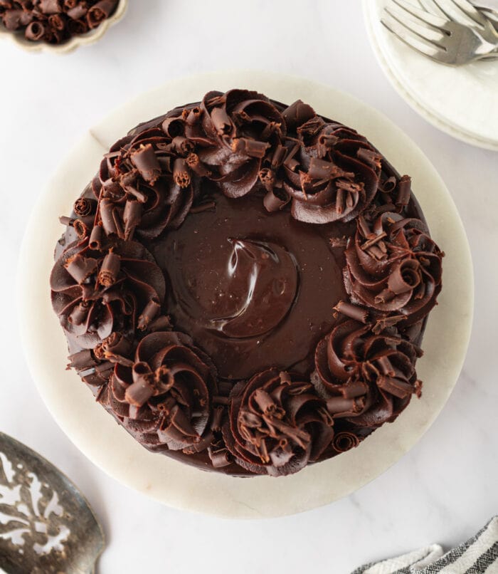 Chocolate Cheesecake decorated with frosting and chocolate curls