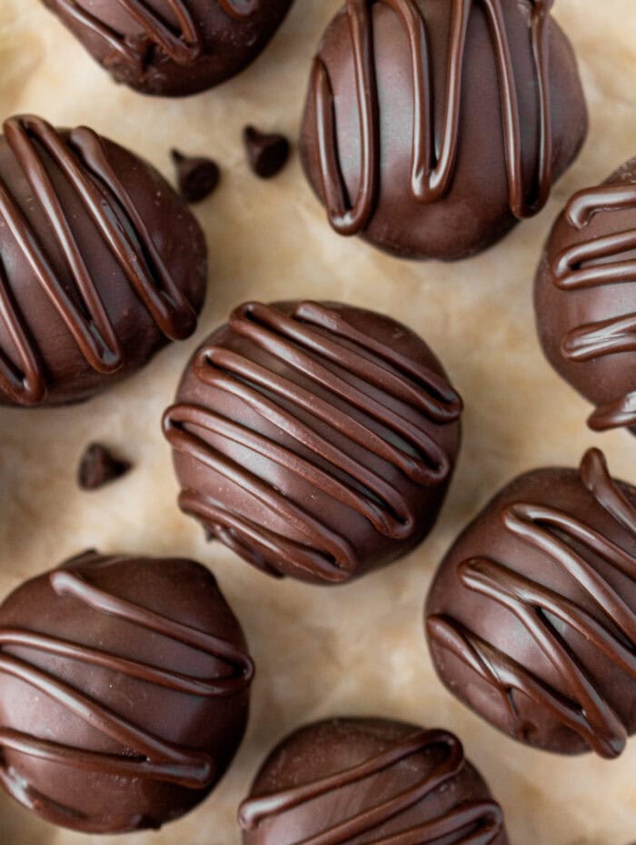 Cookie Dough Truffles dipped in chocolate with a chocolate drizzle