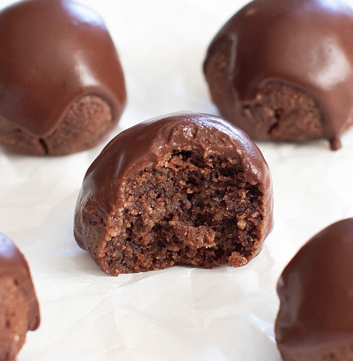 A bite taken from a chocolate donut 