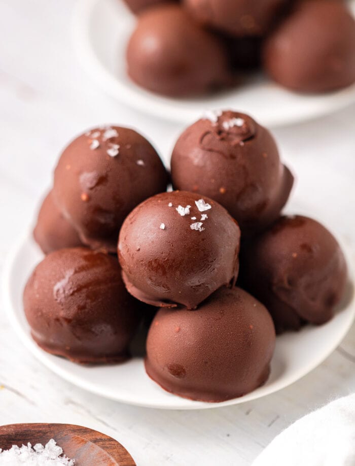 Peanut butter balls on a plate and topped with coarse salt