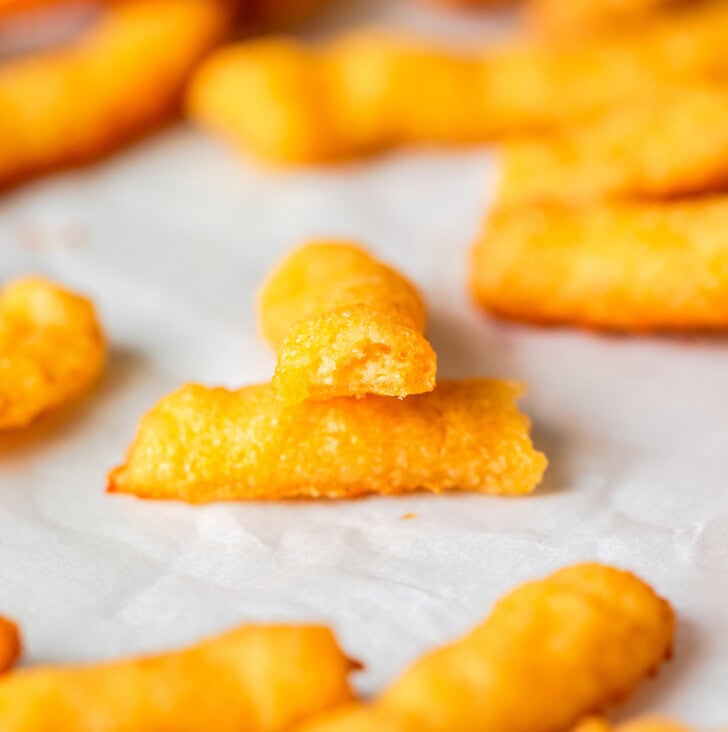 A keto Cheeto cut in half