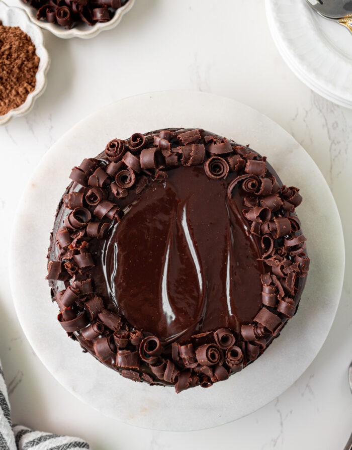 Chocolate cake with frosting and chocolate pieces