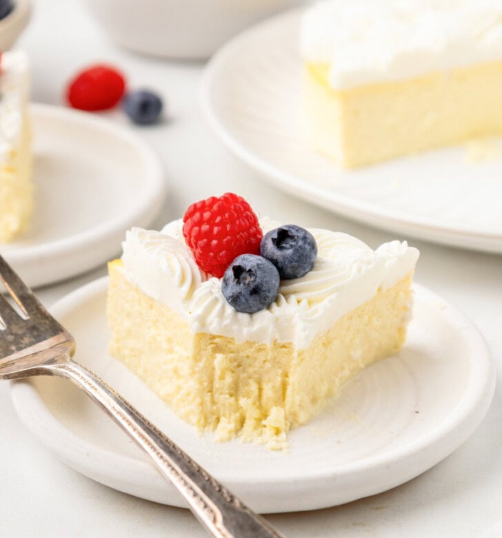 A bite taken from a slice of cheesecake