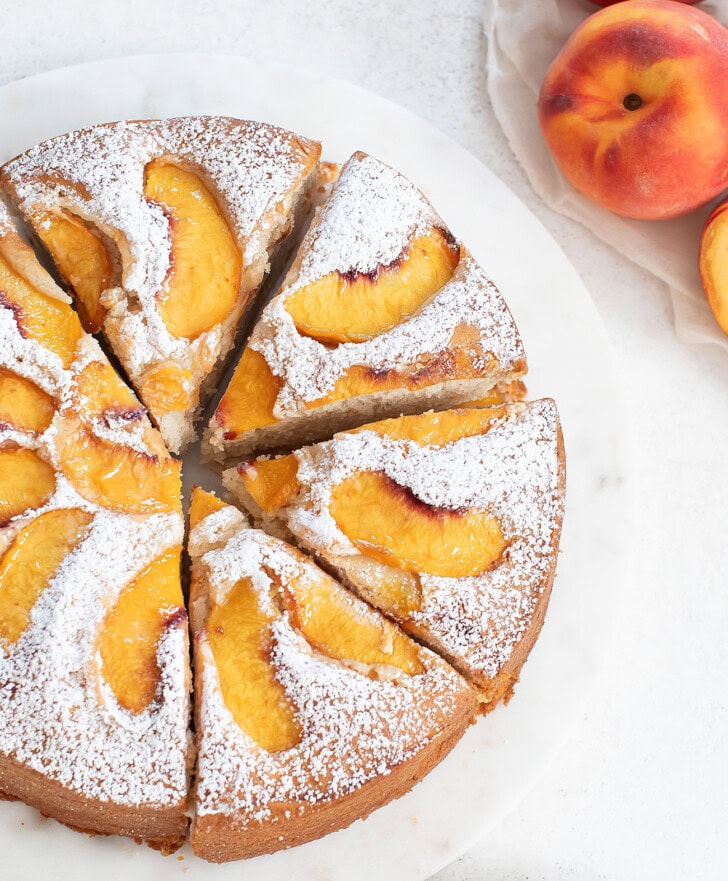 A peach cake cut into slices