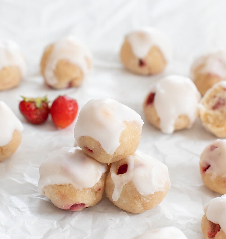 A stack of glazed strawberry donut holes