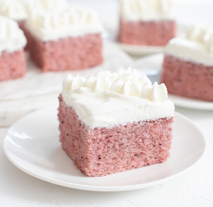 A slice of cake topped with whipped cream