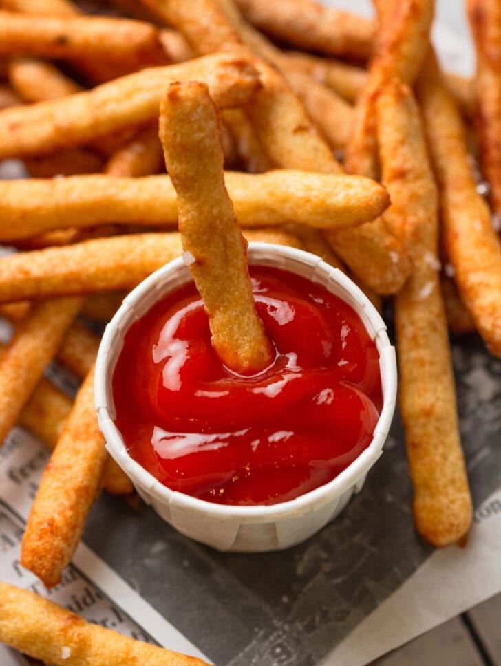 A French fry dipped in ketchup