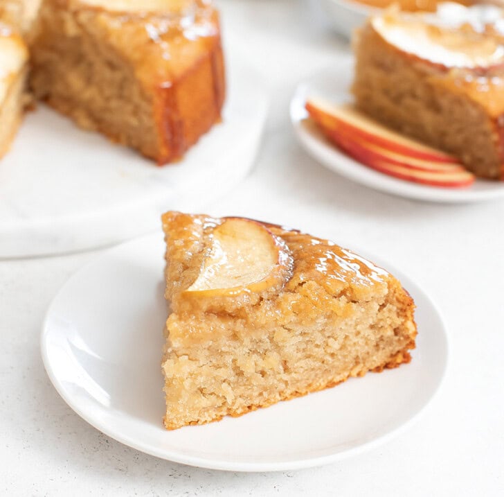 A slice of apple cake with an apple slice on top
