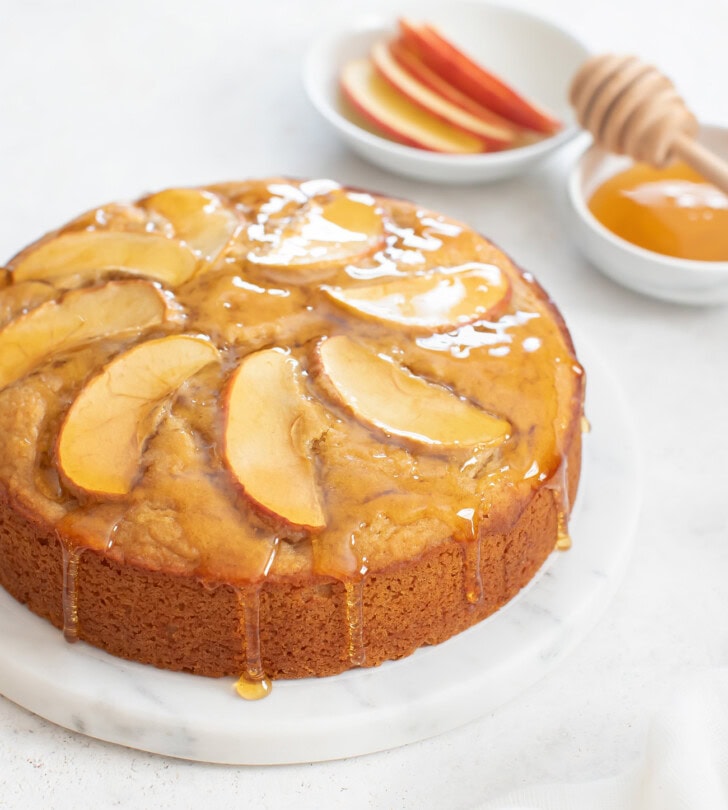 An apple cake with honey drizzled on top