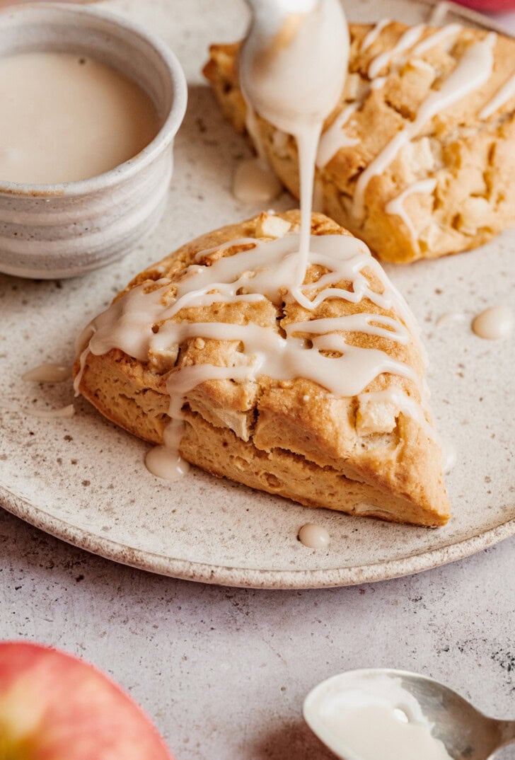 Drizzling icing on top of an apple scone