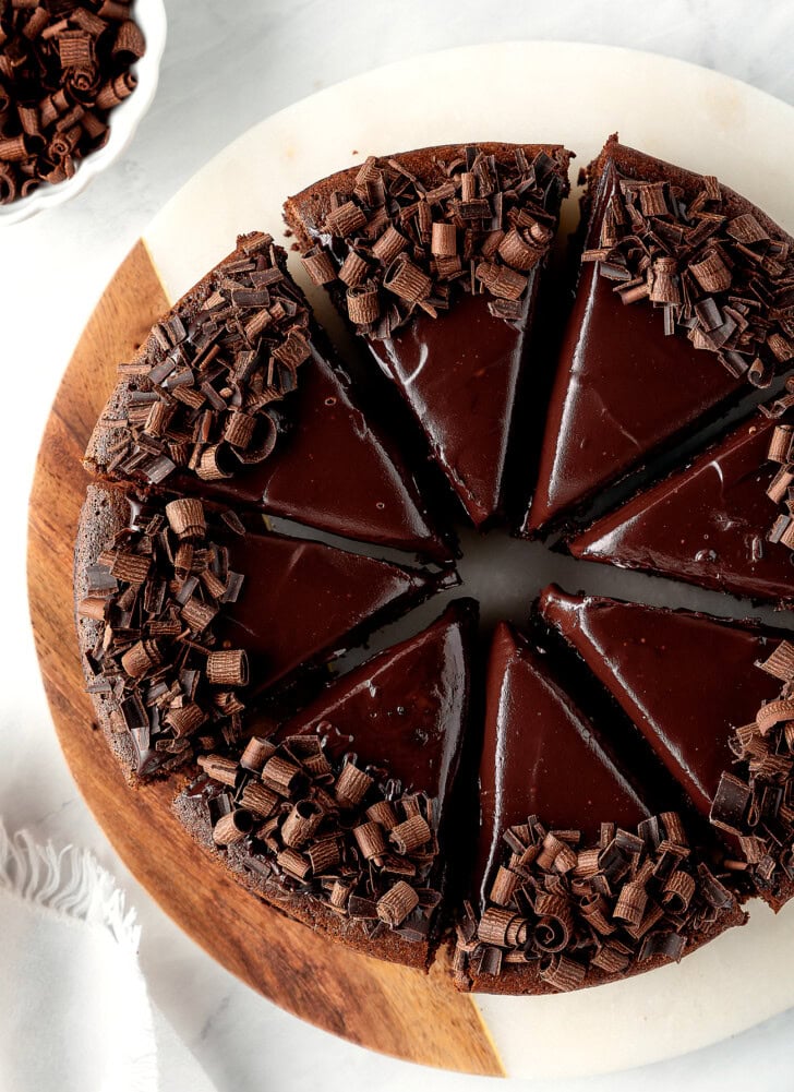 A chocolate cake decorated with chocolate frosting and chocolate curls