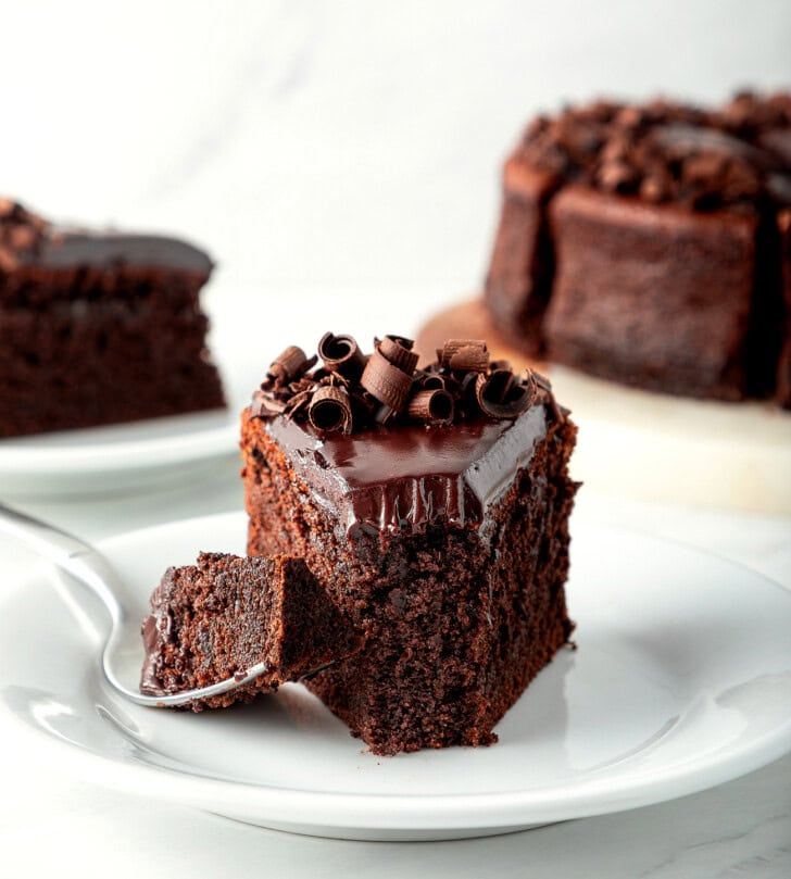 A slice of chocolate cake with a bite on a fork