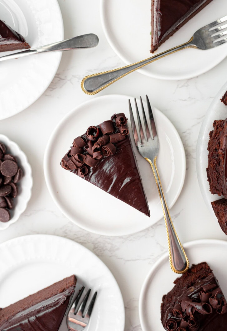 Slices of chocolate cake on white plates