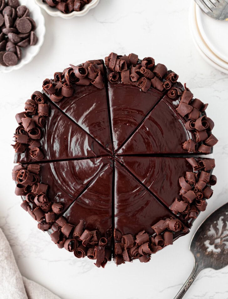 A chocolate cake decorated with chocolate frosting and chocolate curls
