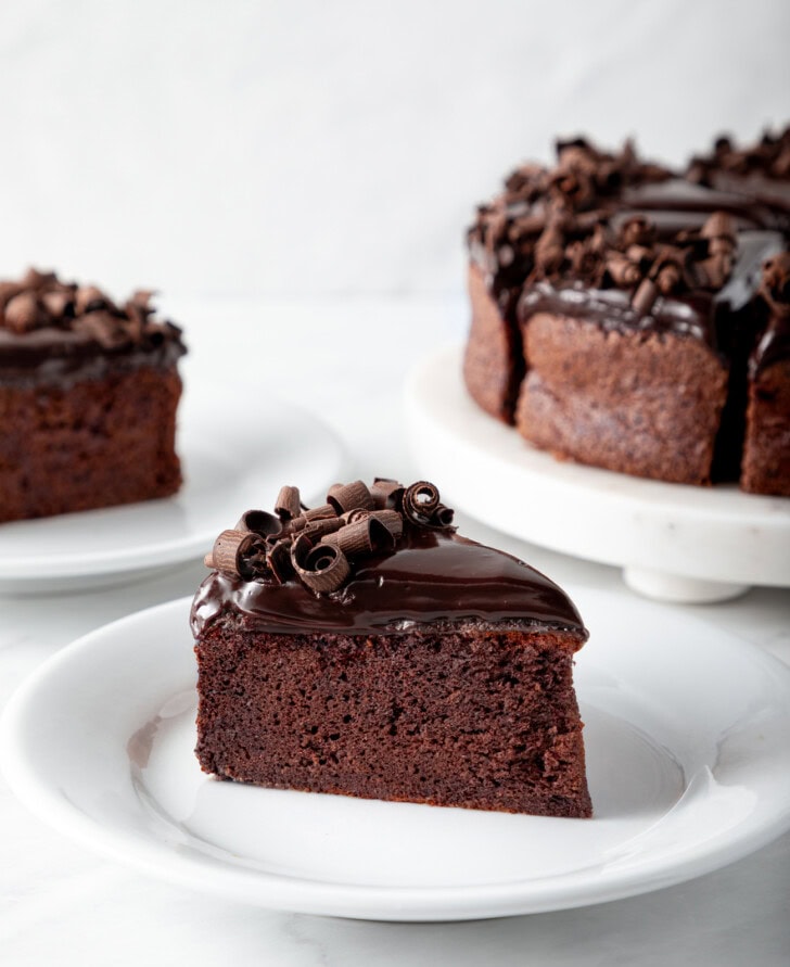 A slice of chocolate cake on a small white plate