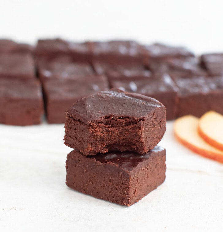 A piece of apple fudge with a bite taken from it