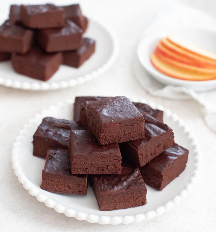A pile of apple fudge on a small white plate