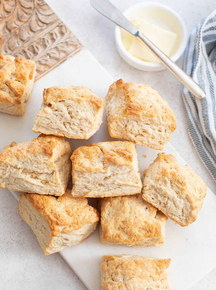 Biscuits on a serving board with butter in a dish