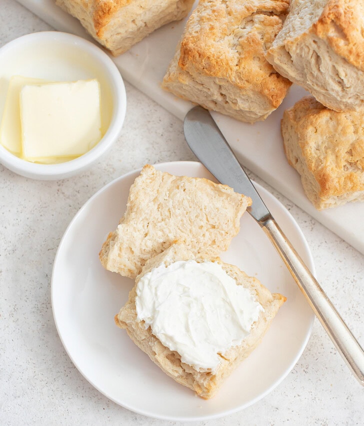 A biscuit cut in half with butter