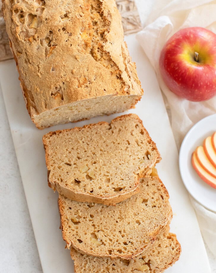 An apple loaf with three slices cut