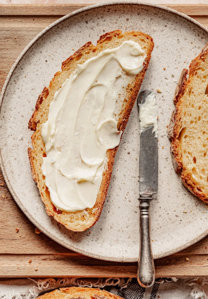 A slice of pumpkin bread with spread on it