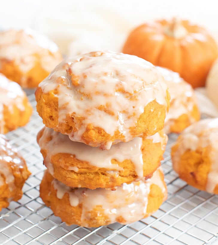 A stack of three pumpkin fritter on a cooling rack