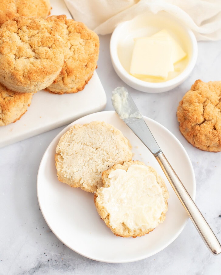 A biscuit cut in half with butter