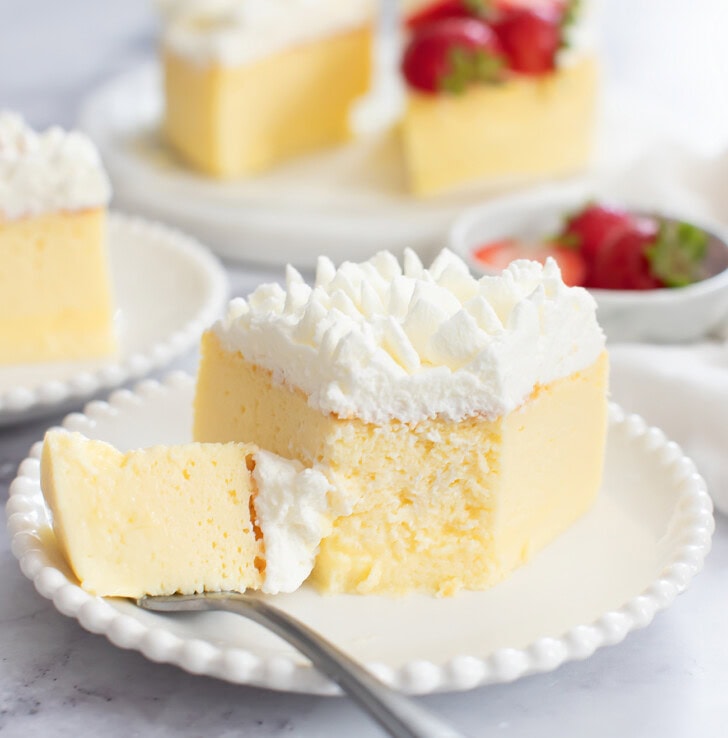 A bite taken from a slice of cheesecake