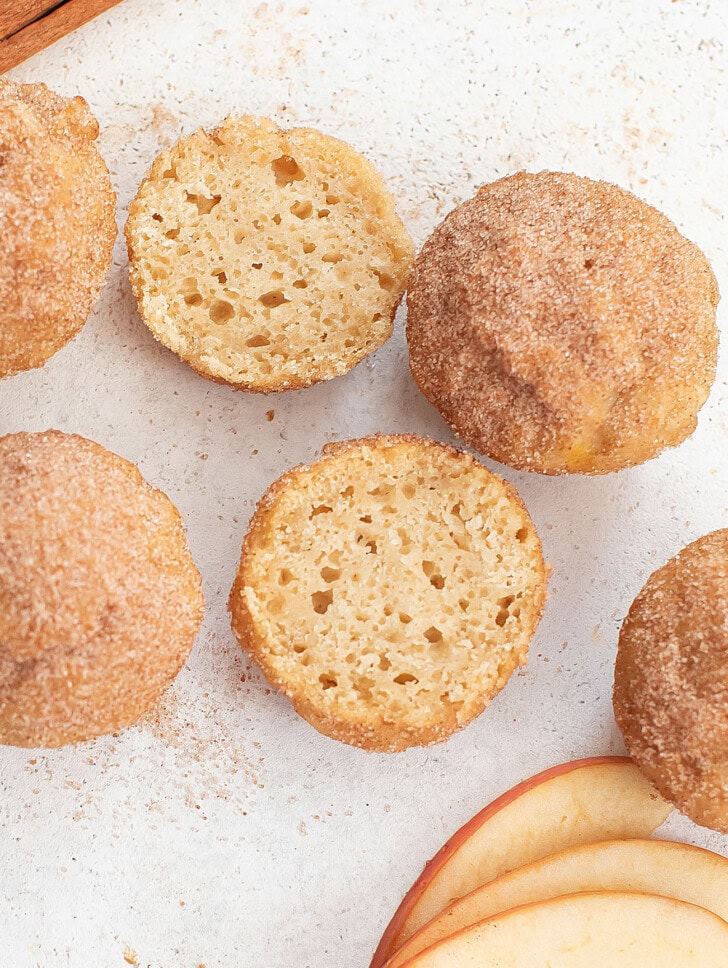 An apple donut hole cut in half with a cake-like texture