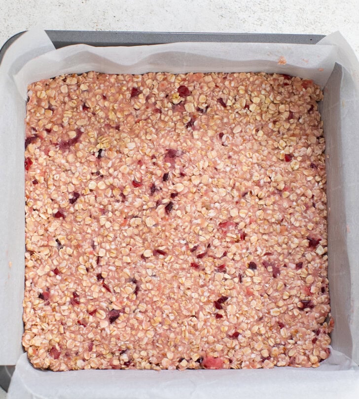Cranberry Oatmeal Bar mixture spread in a prepared baking pan