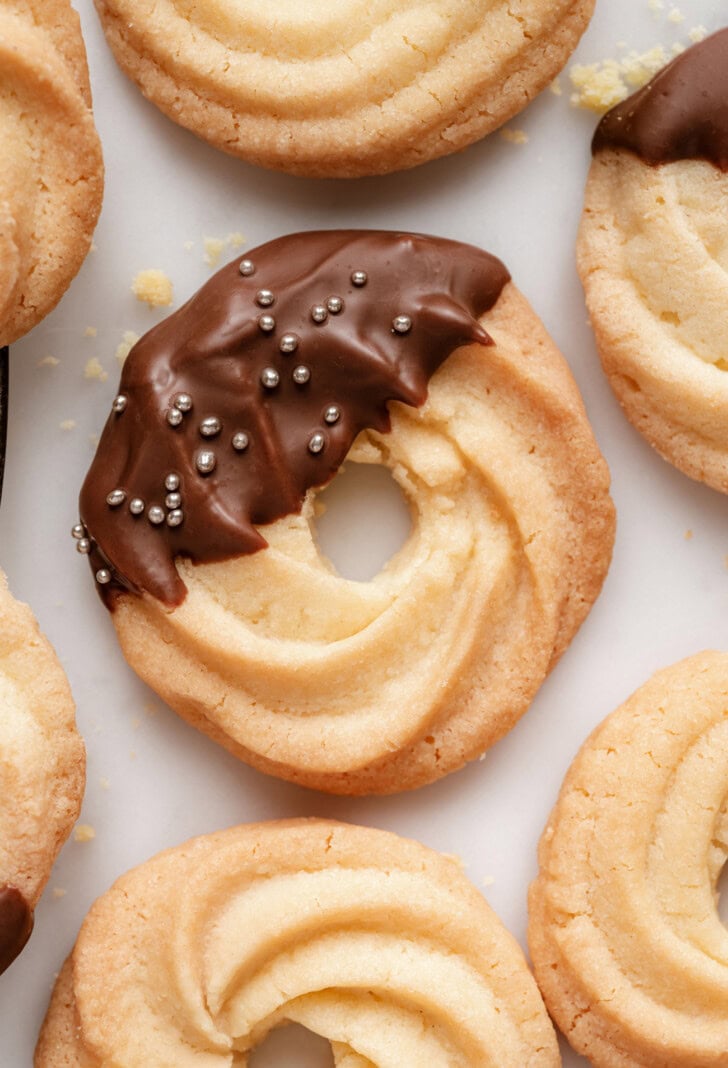 Butter cookies dipped in chocolate with sprinkles