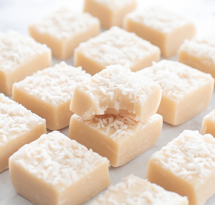 A bite taken from a piece of coconut fudge