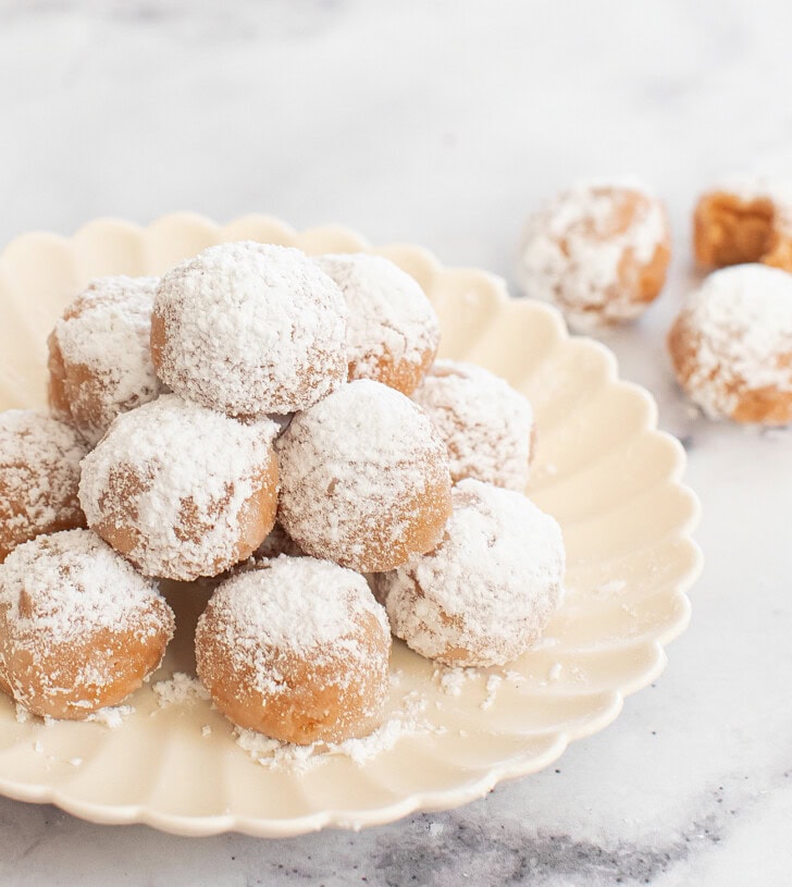 A pile of Snowball Cookies on a plate