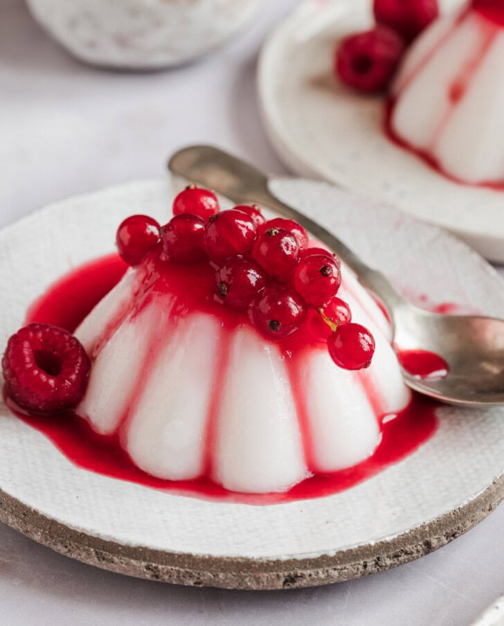 Panna Cotta on a plate with a spoon