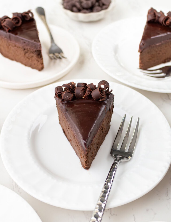 Slices of chocolate cake with chocolate ganache and chocolate curls on top