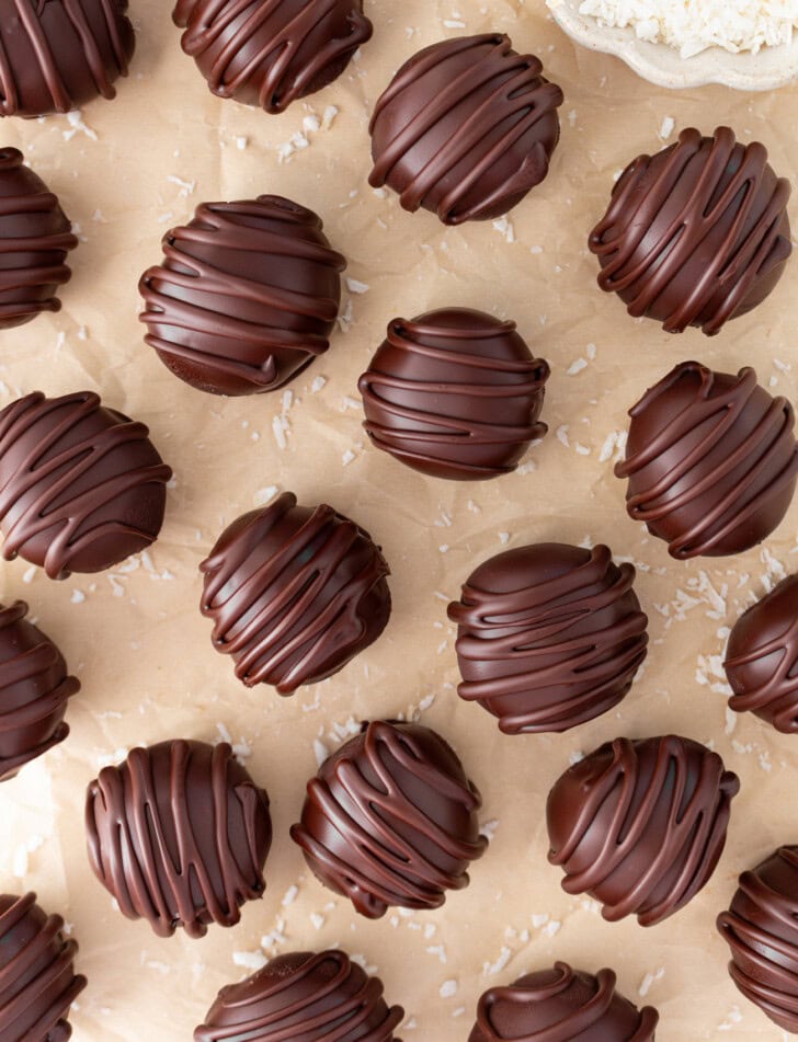 Coconut truffles with a chocolate drizzle on top