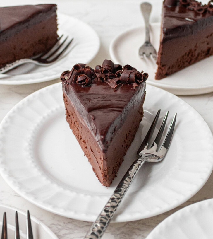 A slice of chocolate cake on a plate with a fork