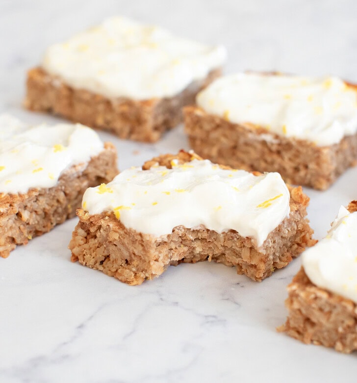 Lemon Oatmeal Bars with frosting and lemon zest on top