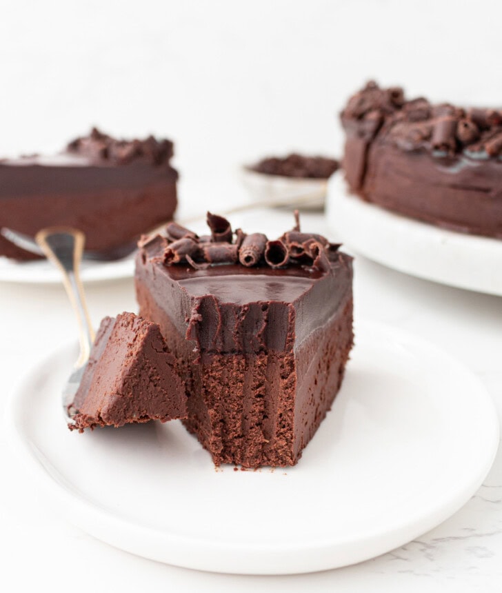 A bite taken from a slice of no bake chocolate cake