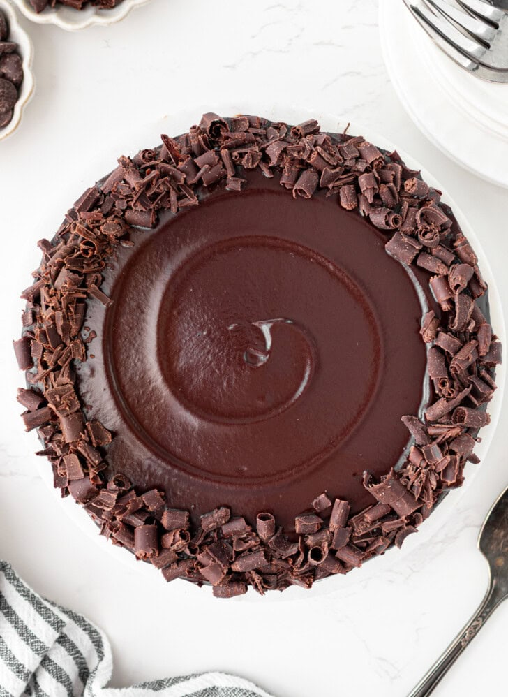 A chocolate cake decorated with chocolate frosting and chocolate curls