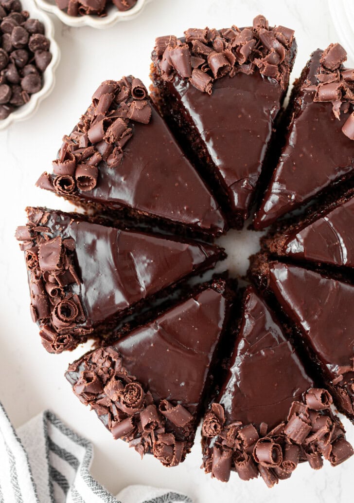 A chocolate cake decorated with chocolate frosting and chocolate curls