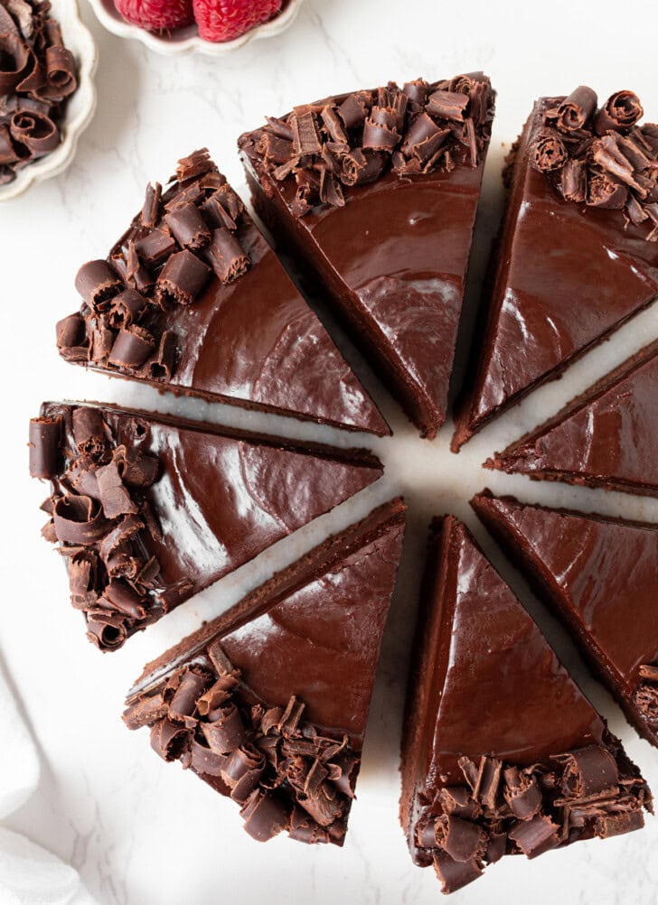 A No Bake Chocolate Cake topped with frosting and chocolate curls