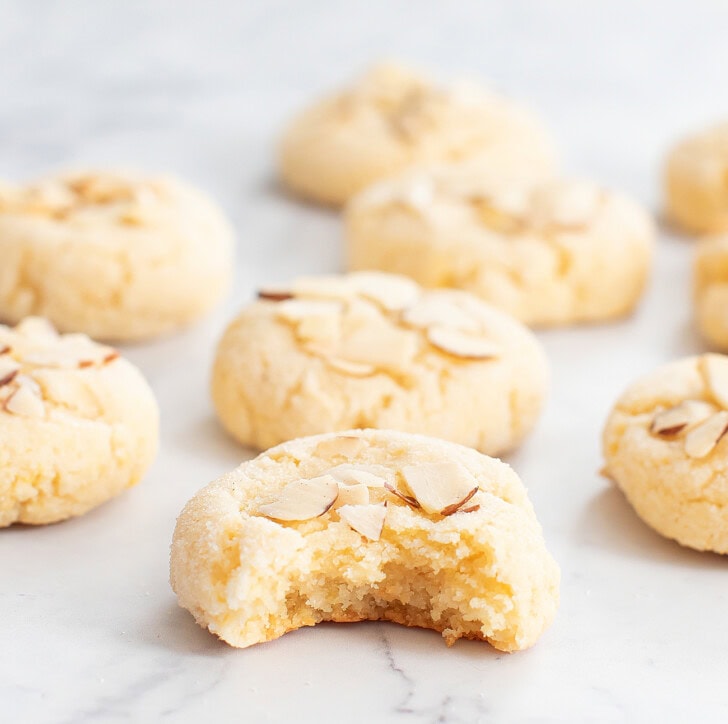 An almond cookie with a bite taken from it